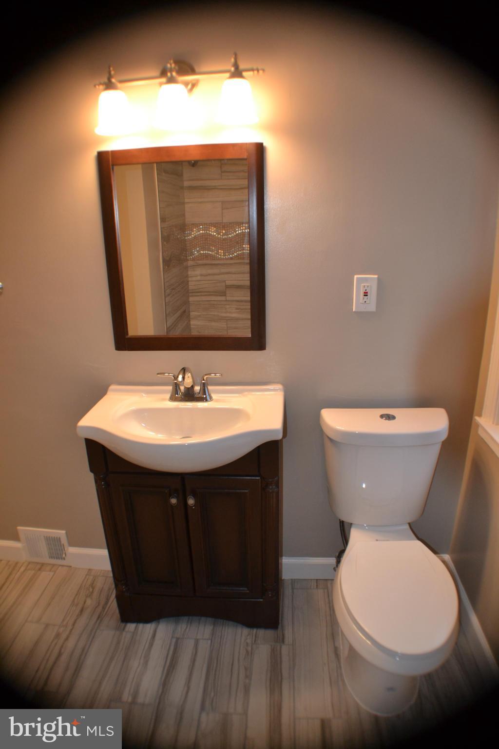 1424 Cedarcroft Road Baltimore, MD 21239 - Photo 15 of 16 a bathroom with a sink and a toilet