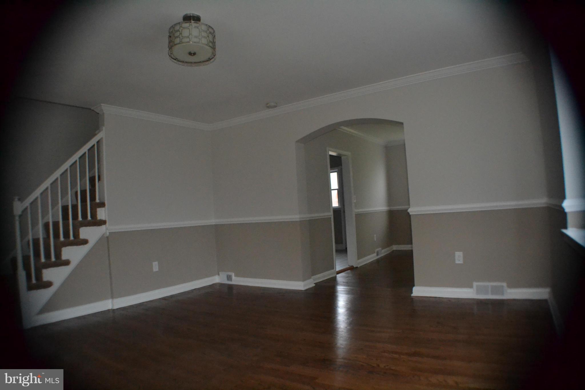 1424 Cedarcroft Road Baltimore, MD 21239 - Photo 3 of 16 a view of an empty room with wooden floor
