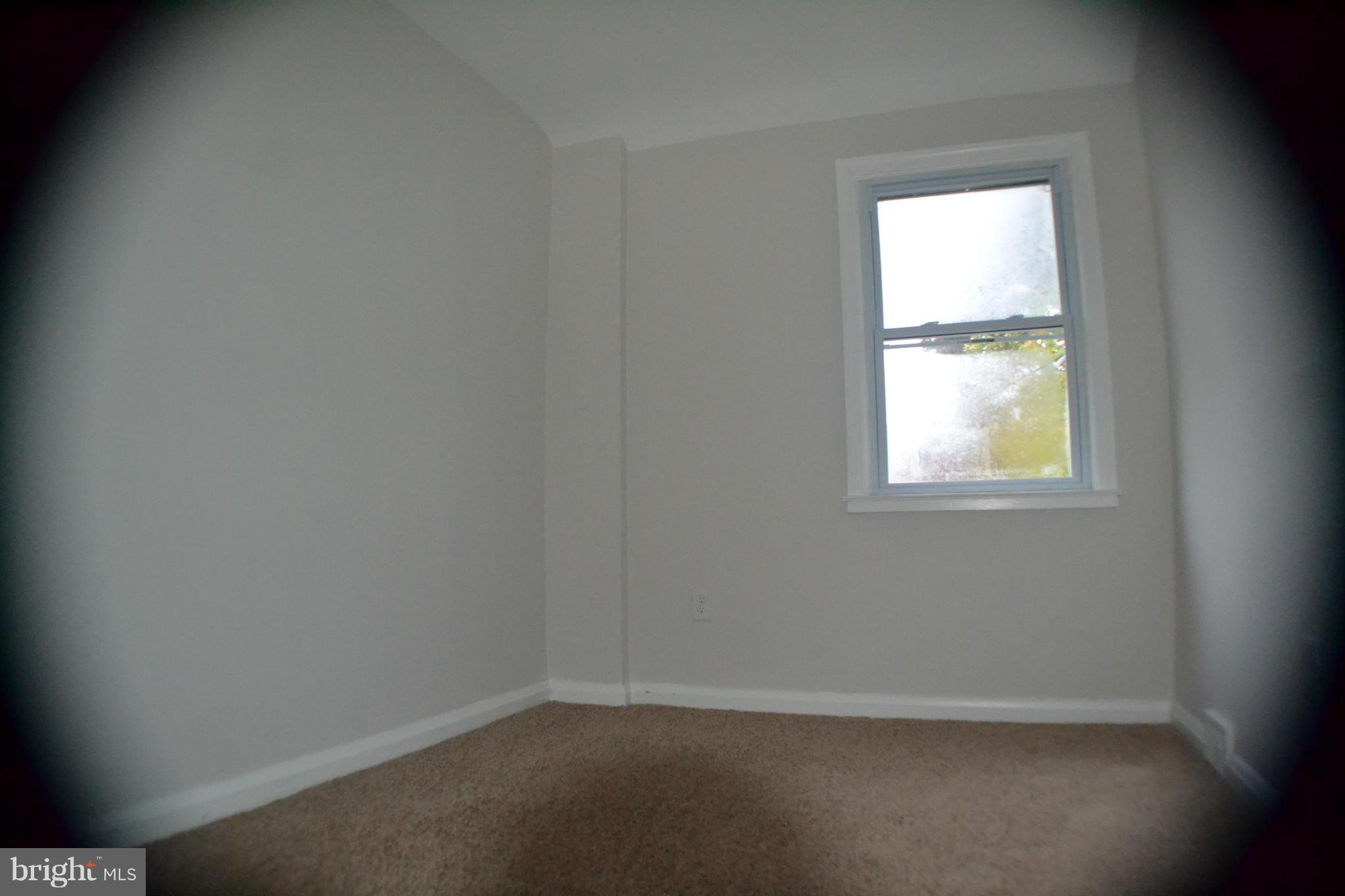 1424 Cedarcroft Road Baltimore, MD 21239 - Photo 10 of 16 an empty room with a window