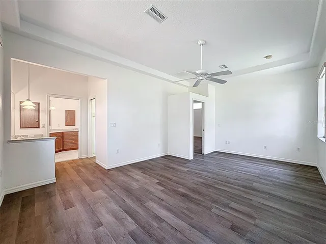 a view of a kitchen with wooden floor and a kitchen