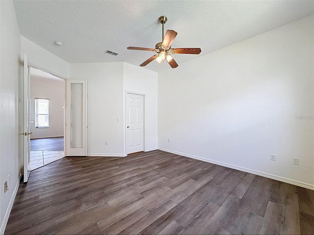 9237 Penelope Drive Weeki Wachee, FL 34613 - Photo 18 of 19 wooden floor in an empty room with a window