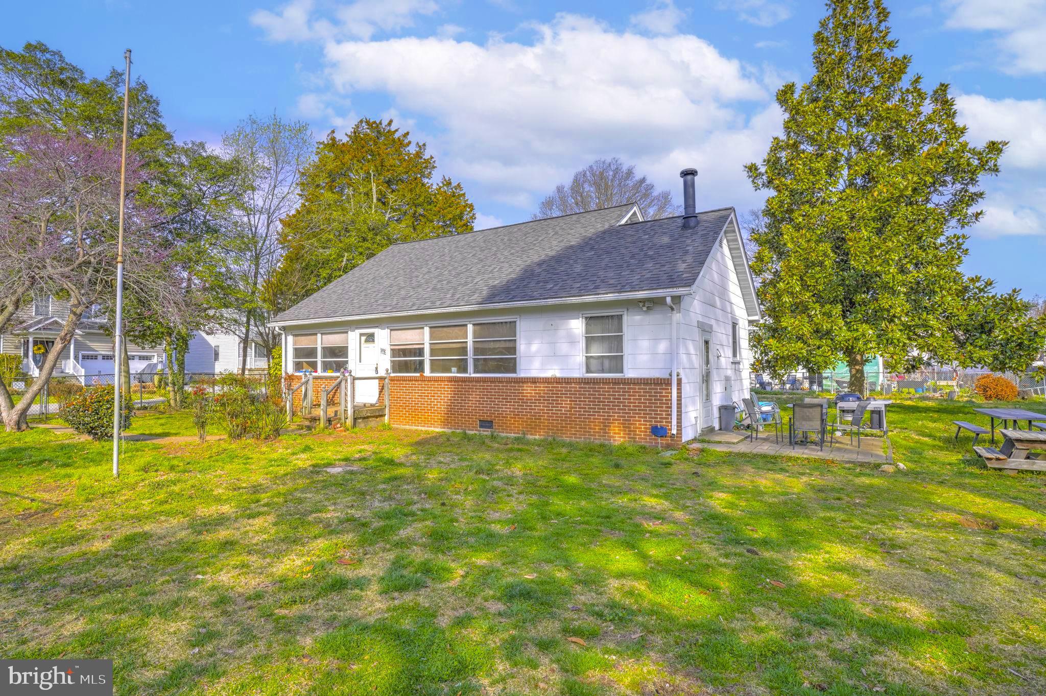 3715 5th Avenue Edgewater, MD 21037 - Photo 1 of 34 a front view of a house with a yard
