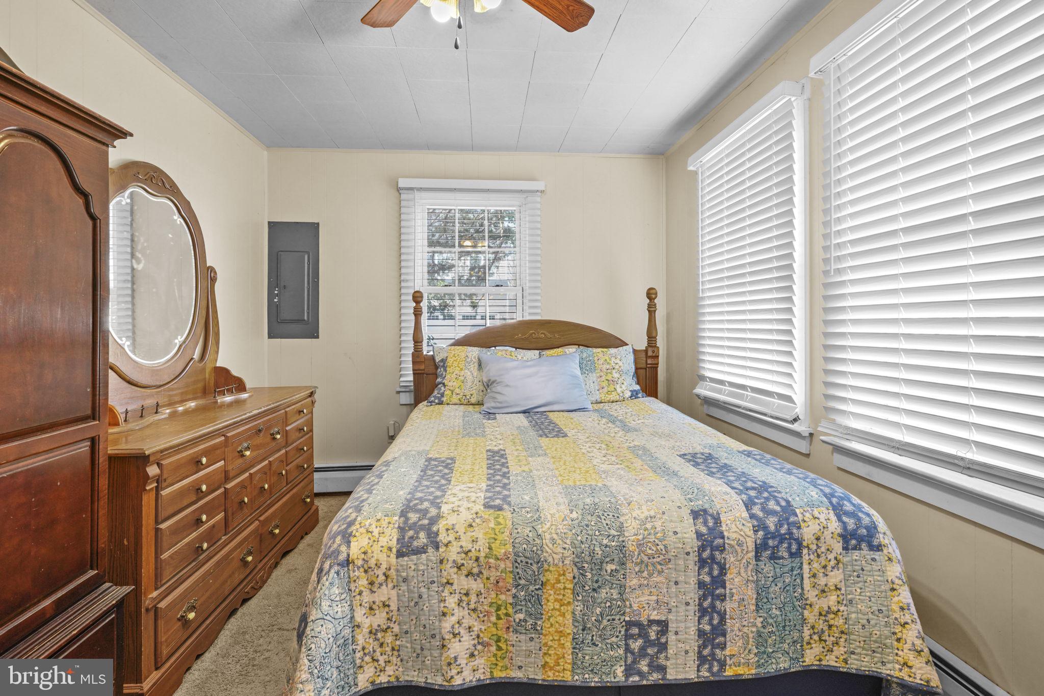 3715 5th Avenue Edgewater, MD 21037 - Photo 16 of 34 a bedroom with a bed and a chandelier