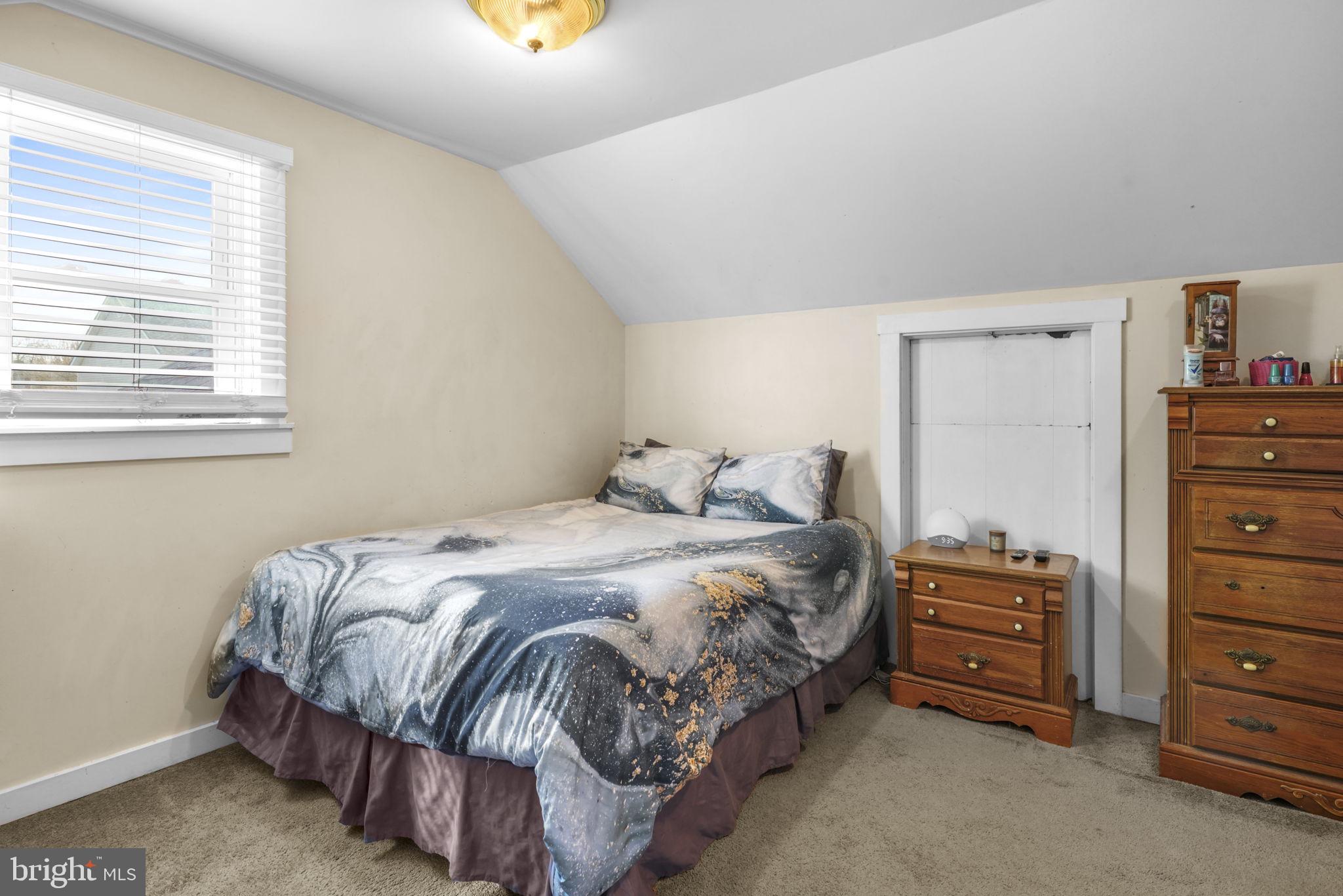 3715 5th Avenue Edgewater, MD 21037 - Photo 20 of 34 a bedroom with a bed and a dresser