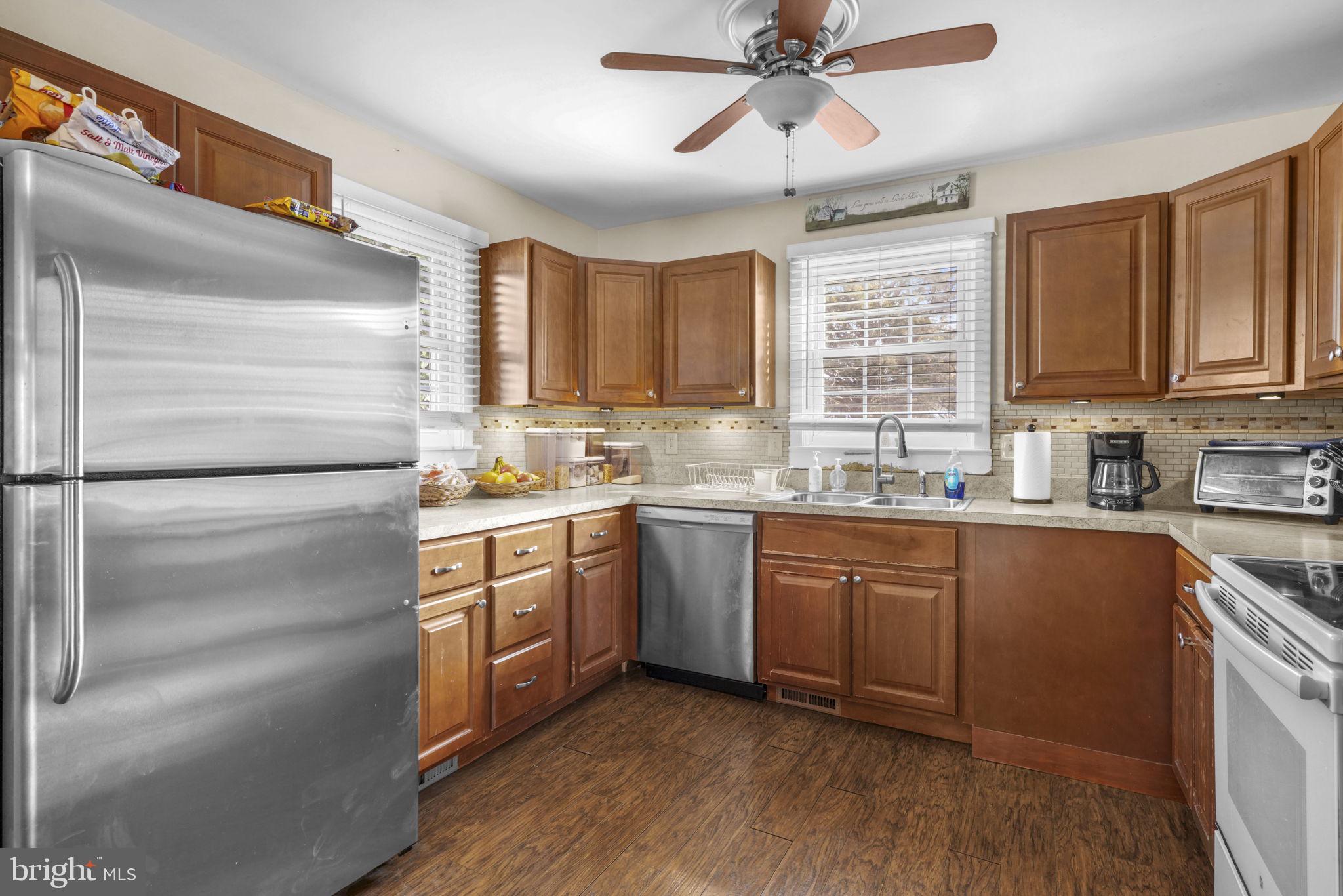 3715 5th Avenue Edgewater, MD 21037 - Photo 7 of 34 a kitchen with a refrigerator stove top oven and sink
