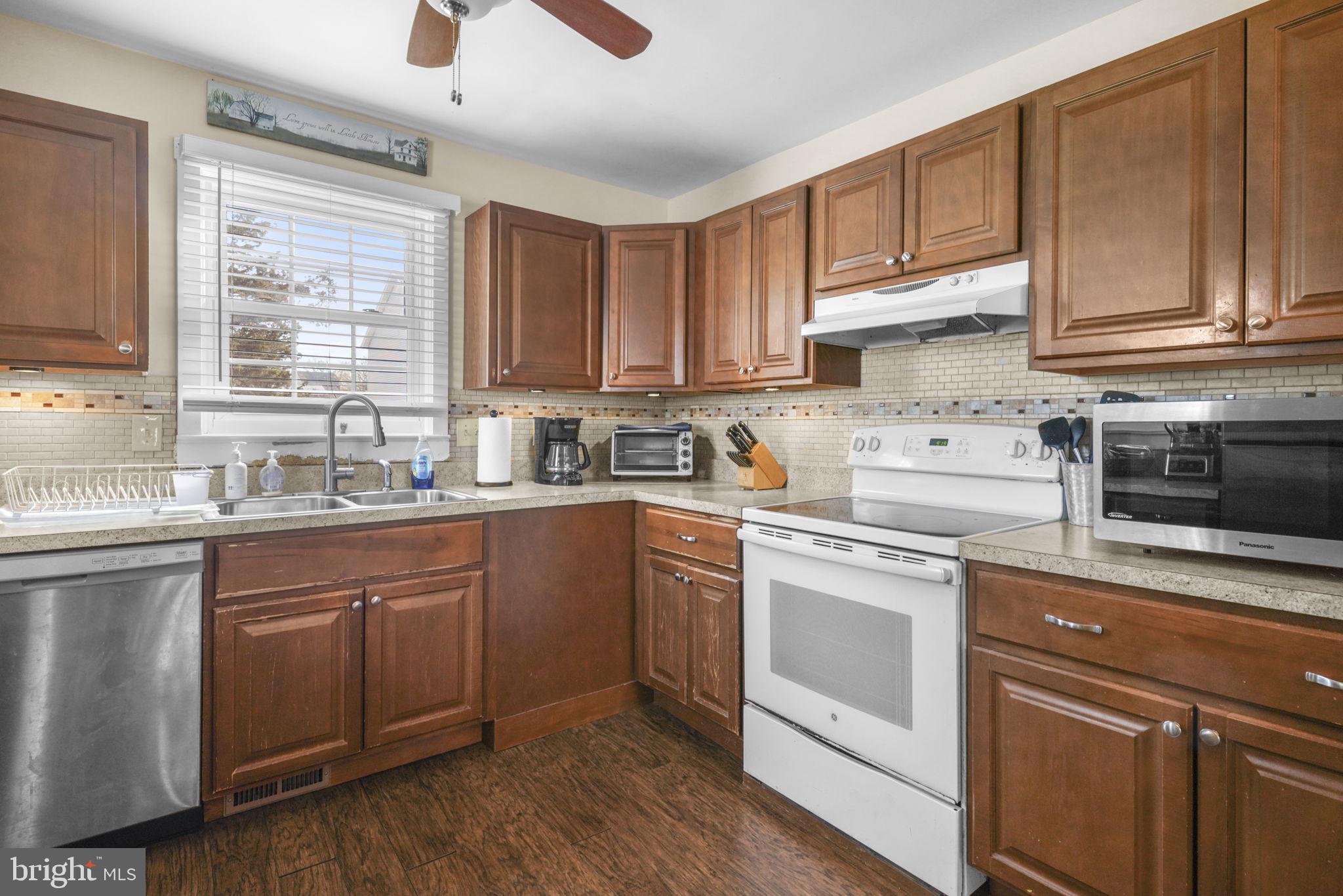 3715 5th Avenue Edgewater, MD 21037 - Photo 8 of 34 a kitchen with cabinets appliances a sink and a window