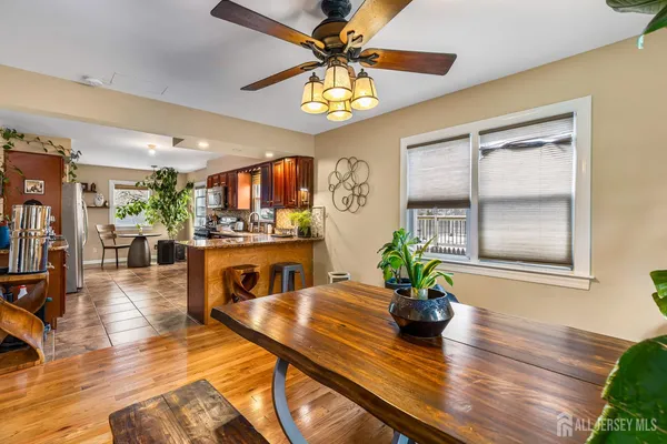 a living room with furniture dining table and a potted plant