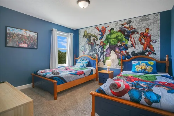 a bedroom with baby bed and window