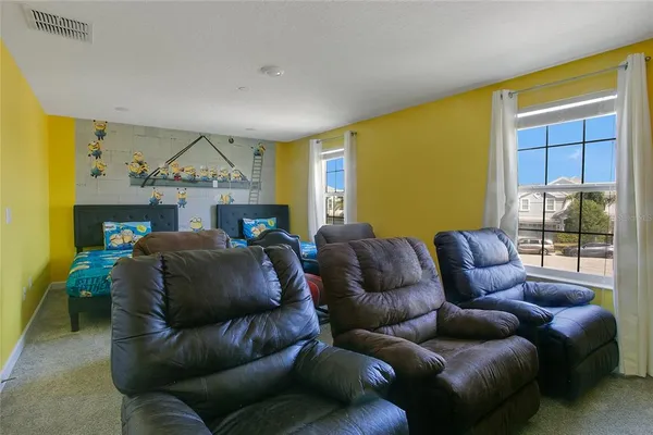 a living room with furniture a ceiling fan and a window