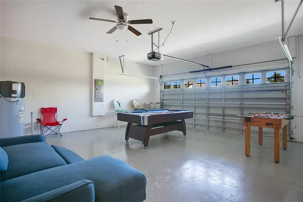 a living room with furniture a air conditioner and a window