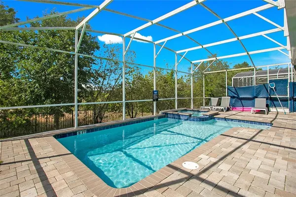 a view of a house with a backyard and sitting area