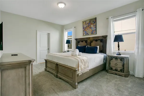 a bedroom with a bed and a painting on the wall