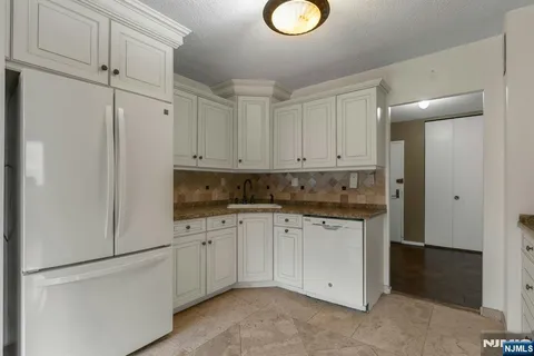 a kitchen with white cabinets