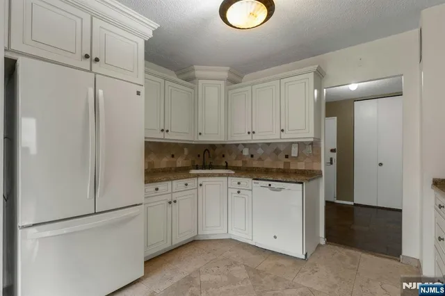 a kitchen with white cabinets