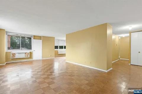 a view of a big room with windows and pillars in it