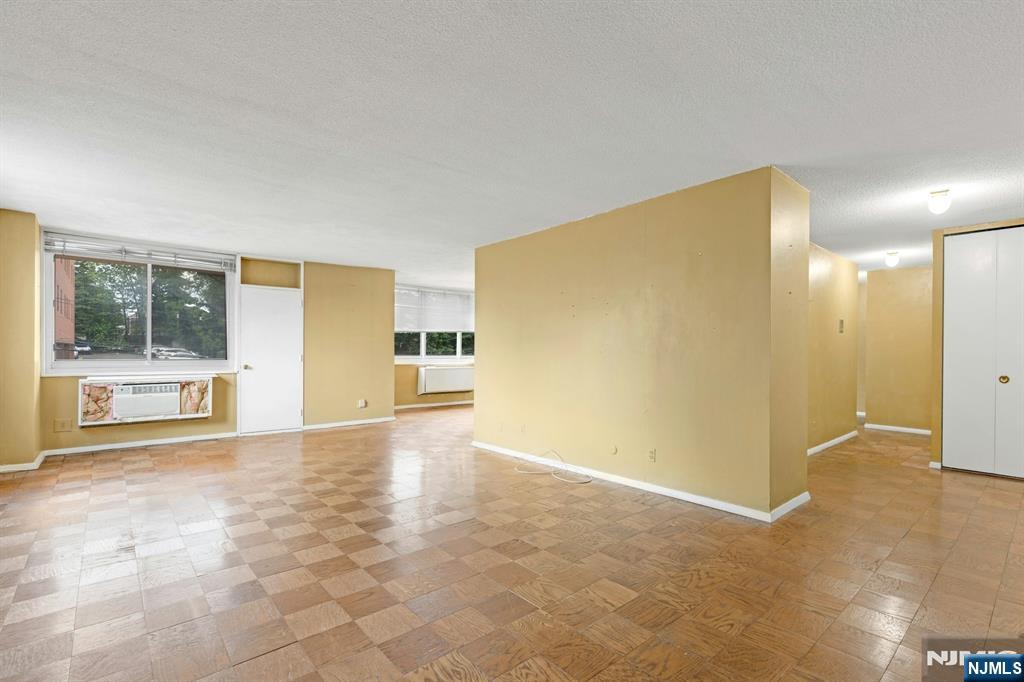 2150 Center Avenue, Unit 2E Fort Lee, NJ 07024 - Photo 2 of 34 a view of a big room with windows and pillars in it