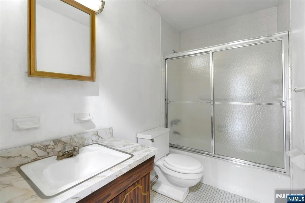 2150 Center Avenue, Unit 2E Fort Lee, NJ 07024 - Photo 21 of 34 a bathroom with a sink toilet and shower