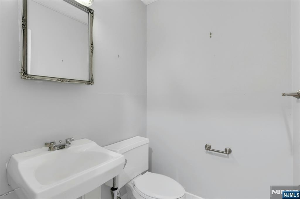 2150 Center Avenue, Unit 2E Fort Lee, NJ 07024 - Photo 22 of 34 a bathroom with a sink and a toilet