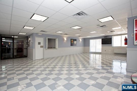 2150 Center Avenue, Unit 2E Fort Lee, NJ 07024 - Photo 29 of 34 a view of a hall with a dining table chairs