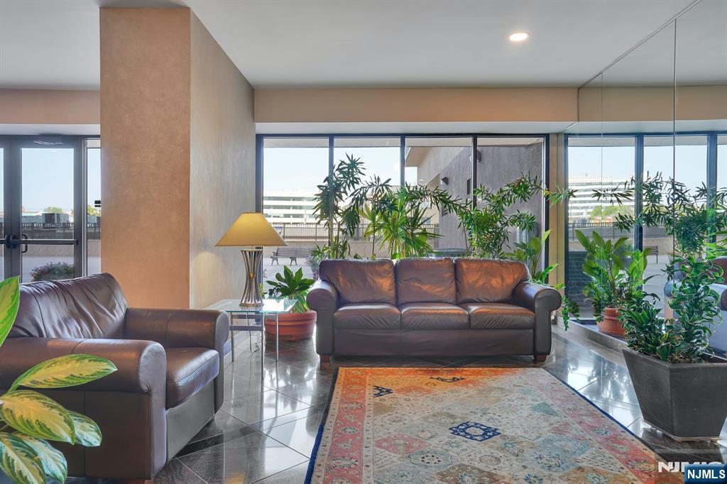 2150 Center Avenue, Unit 2E Fort Lee, NJ 07024 - Photo 33 of 34 a living room with furniture potted plant and a large window