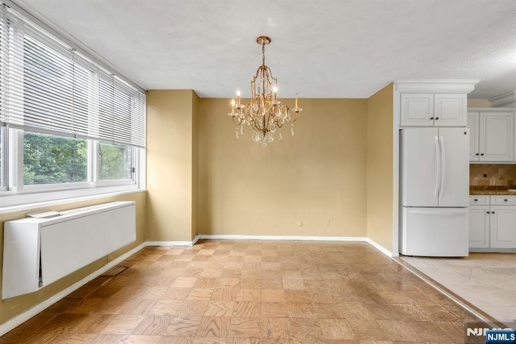 2150 Center Avenue, Unit 2E Fort Lee, NJ 07024 - Photo 7 of 34 a view of a kitchen with a dishwasher cabinets and a large window