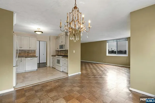a view of a kitchen with a sink and a refrigerator