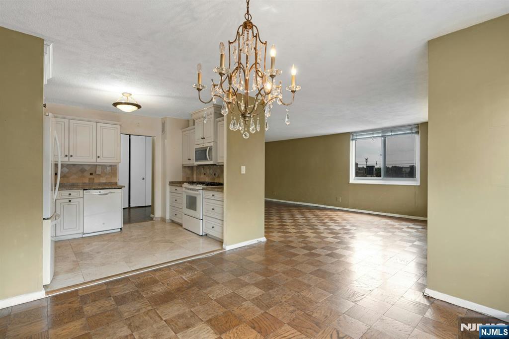 2150 Center Avenue, Unit 2E Fort Lee, NJ 07024 - Photo 8 of 34 a view of a kitchen with a sink and a refrigerator