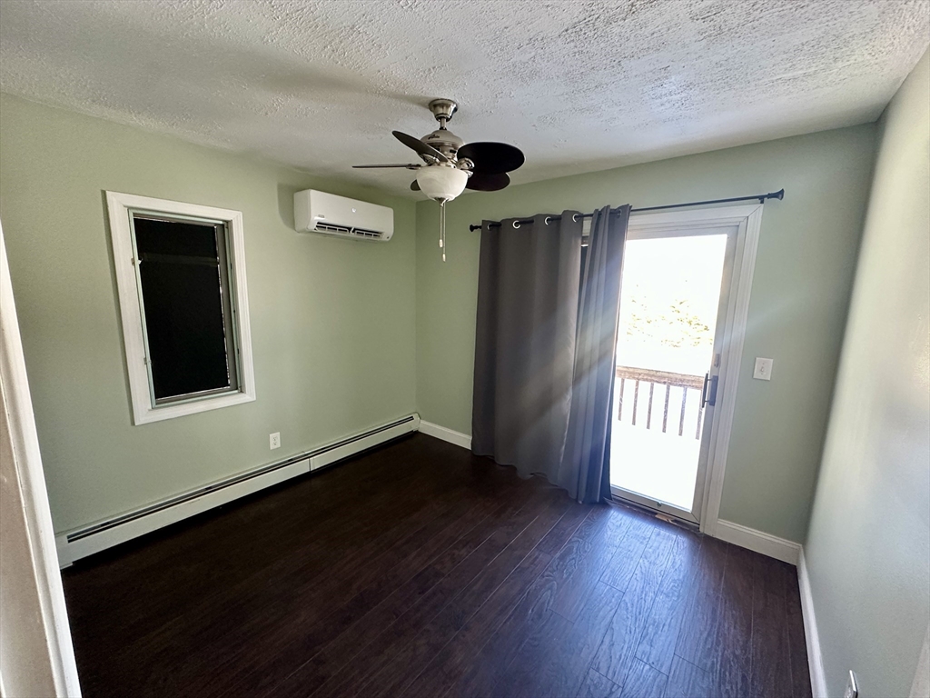 35 Princeton Street Gardner, MA 01440 - Photo 7 of 23 a view of an empty room with a window and wooden floor