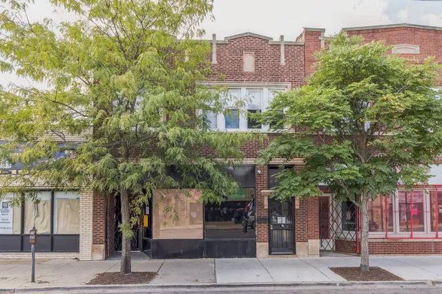 front view of a building with a tree
