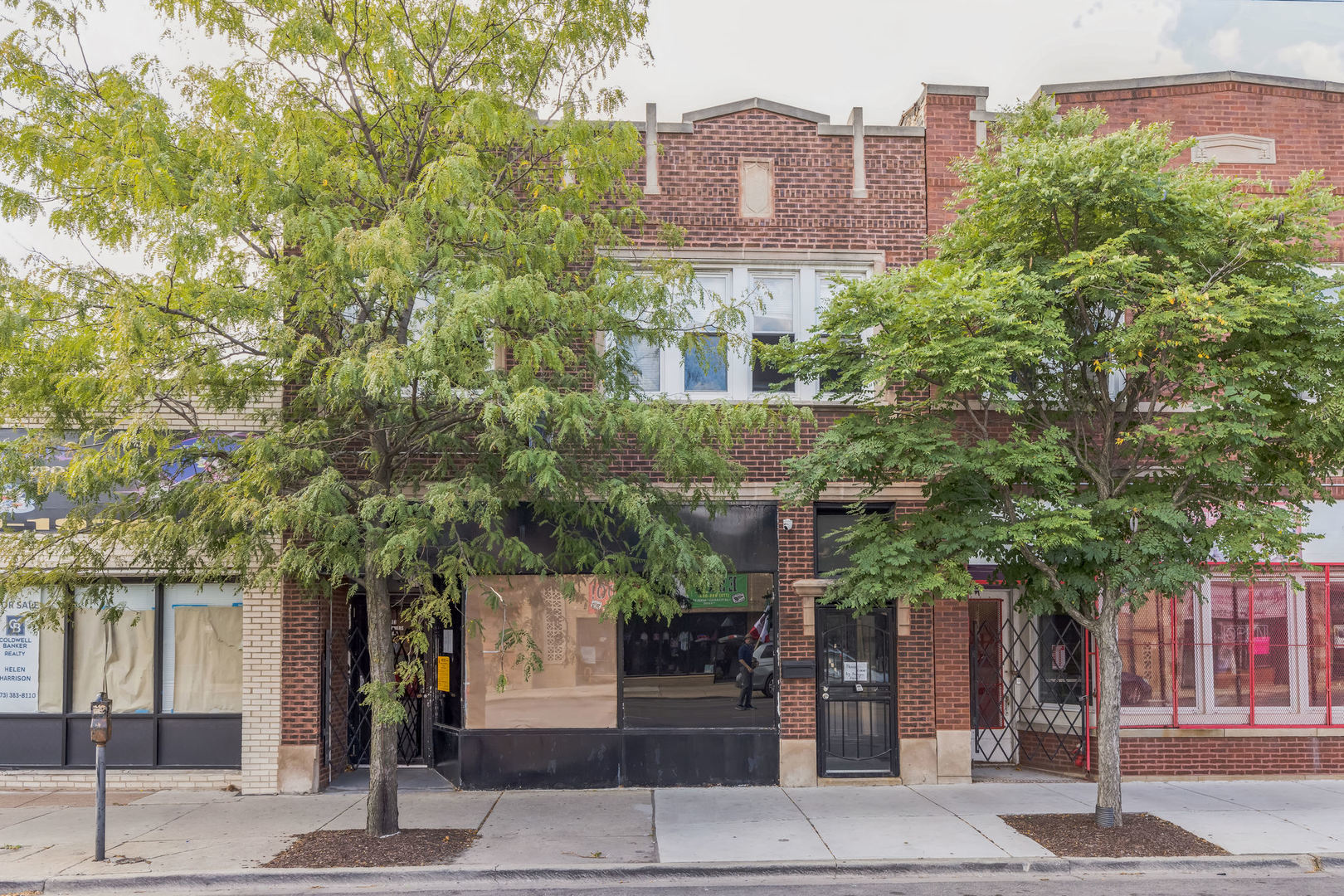 front view of a building with a tree