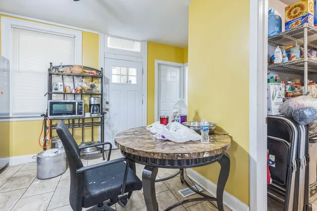a view of a dining room with furniture and a book shelf