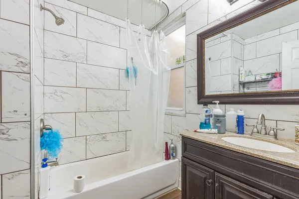 a bathroom with a bathtub and shower