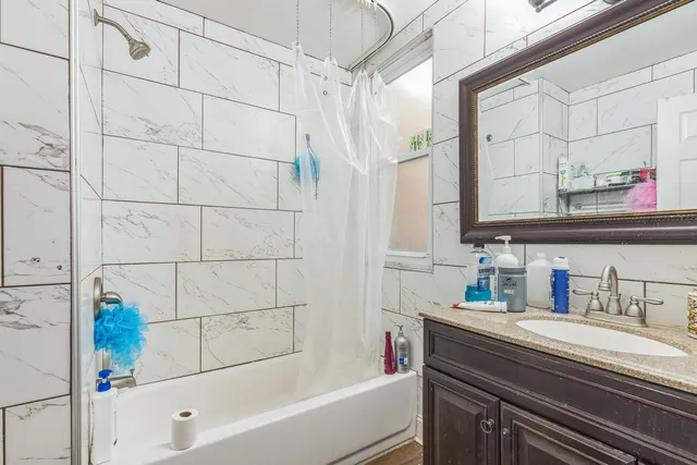 a bathroom with a bathtub and shower