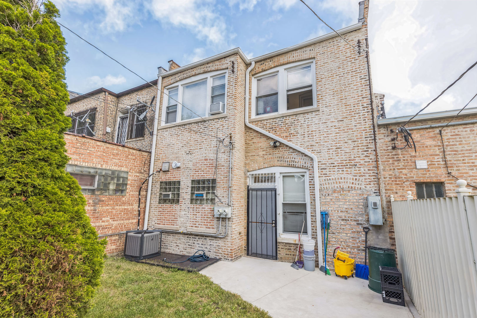 2913 West 63rd Street Chicago, IL 60629 - Photo 19 of 20 a view of a brick house with many windows and a tree