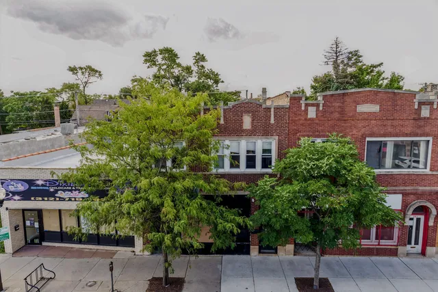 front view of a building with a tree