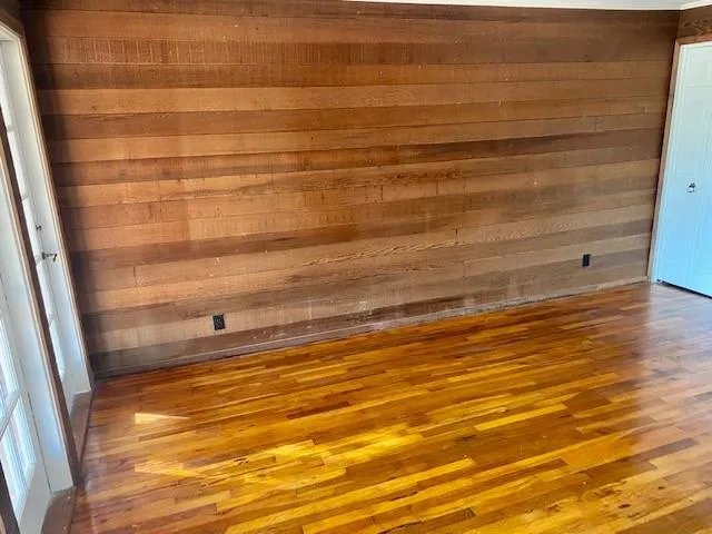 a view of front door with wooden floor and a bathroom