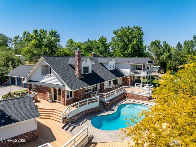 an aerial view of a house with swimming pool garden and patio