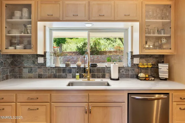 a kitchen with appliances cabinets and a window