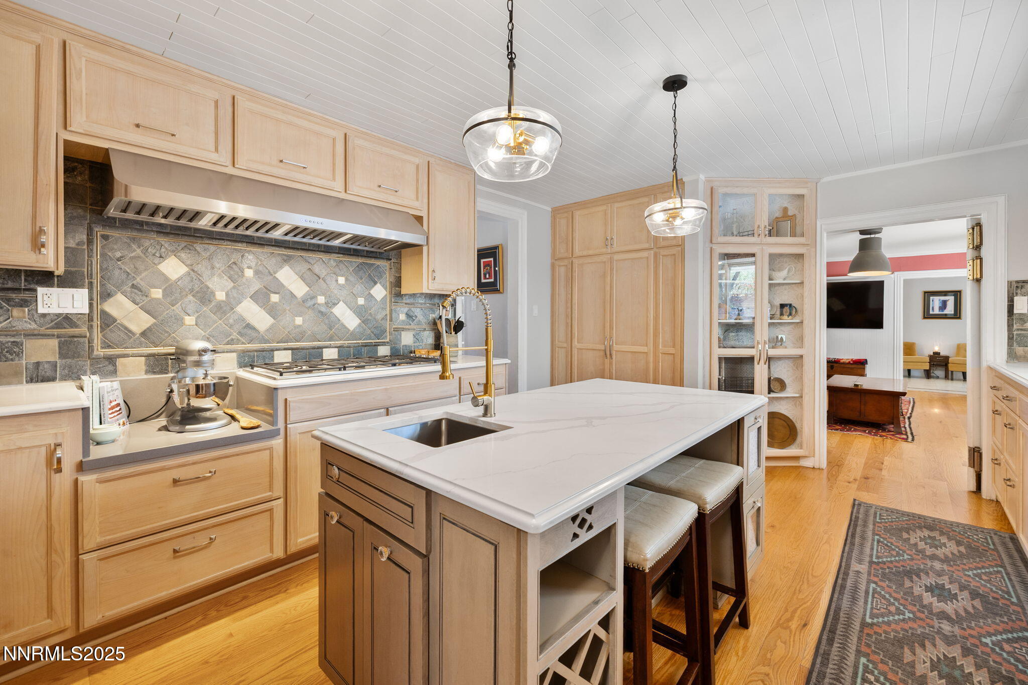 1855 Sierra Sage Lane Reno, NV 89509 - Photo 18 of 34 a kitchen that has a kitchen island a stove a table and chairs in it