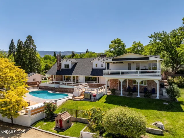 a front view of house with yard and outdoor seating