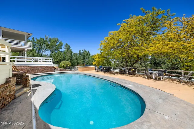 a view of a swimming pool with an outdoor seating