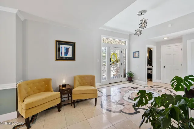 a living room with furniture flowerpot and a chandelier