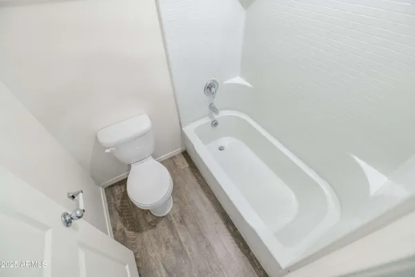 a bathroom with a tub sink and toilet