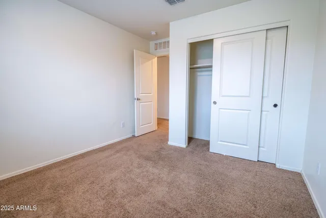 a view of an empty room and closet area