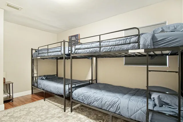 a bedroom with a bed and cabinet