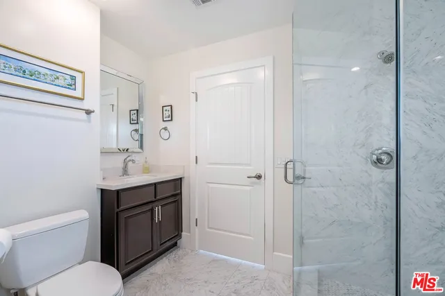 a bathroom with a toilet a sink and shower