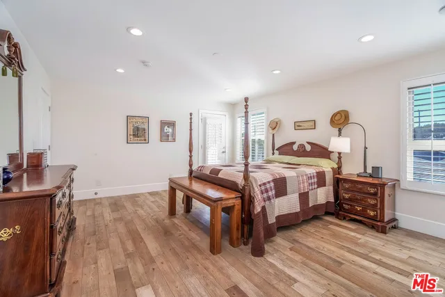 a bedroom with furniture and a wooden floor