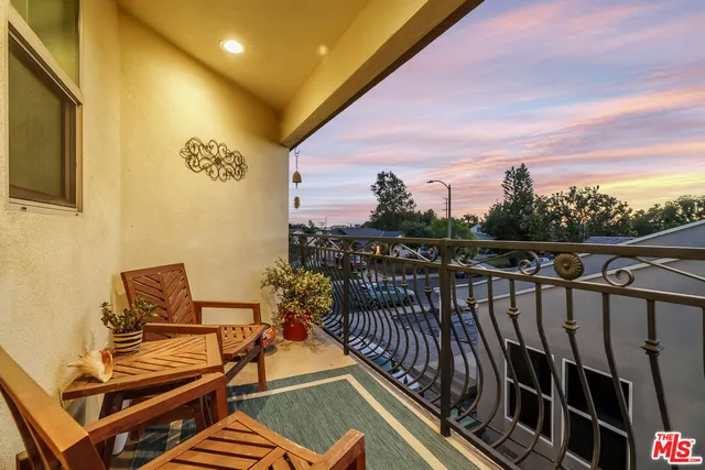a view of a balcony with chairs