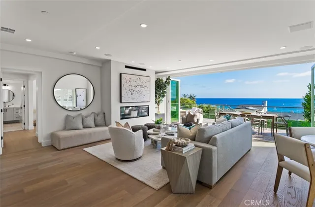 a living room with furniture a rug a clock and a large window
