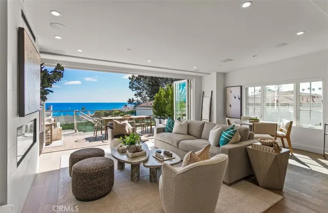a living room with furniture and a floor to ceiling window